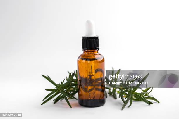 rosemary essential oil and fresh twig. essential oil natural remedies. - etherische olie stockfoto's en -beelden