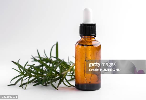 rosemary essential oil and fresh twig. essential oil natural remedies. - oli aromi e spezie foto e immagini stock