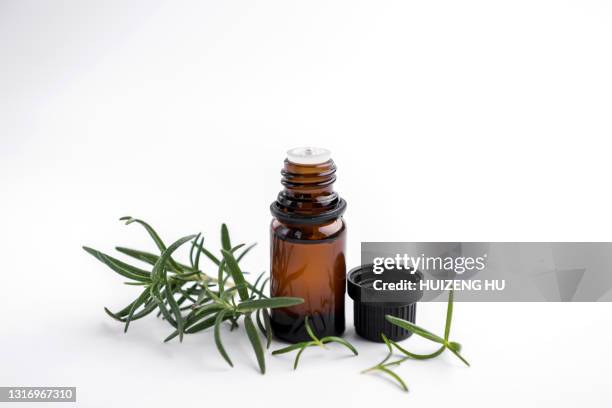 rosemary essential oil and fresh twig. essential oil natural remedies. - oli aromi e spezie foto e immagini stock
