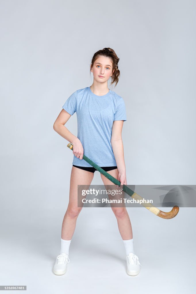 Young teen plays field hockey