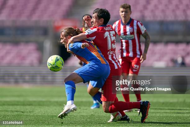 Antoine Griezmann of FC Barcelona competes for the ball with Stefan Savic of Atletico de Madrid during the La Liga Santander match between FC...