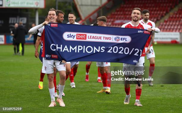 Callum Wright and Sam Smith of Cheltenham Town celebrate their side winning the Sky Bet League 2 after the Sky Bet League Two match between...