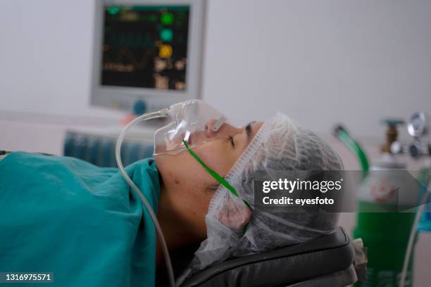 doctors are surgery to patient’s body at operating room. - critical illness stock pictures, royalty-free photos & images