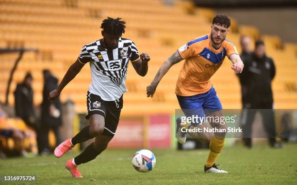 Theo Robinson of Port Vale and Ryan Sweeney of Mansfield Town compete for the ball during the Sky Bet League Two match between Port Vale and...