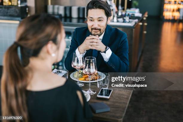 japanese couple at restaurant - couple fine dine stock pictures, royalty-free photos & images