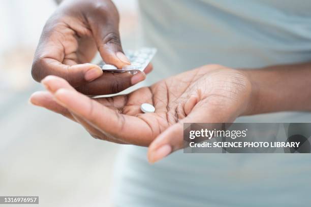 woman taking pills - tabletten stock-fotos und bilder