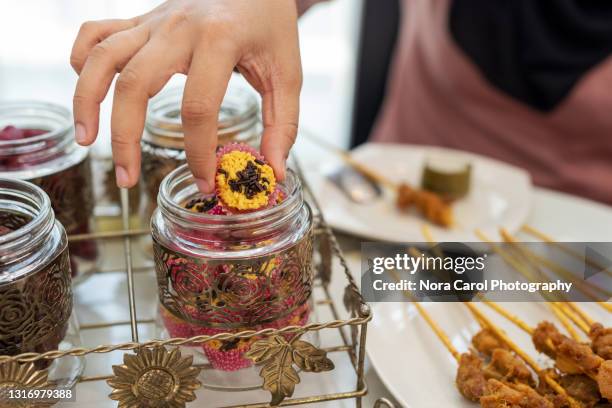 hand picking a cookies from jar - catching food stock pictures, royalty-free photos & images