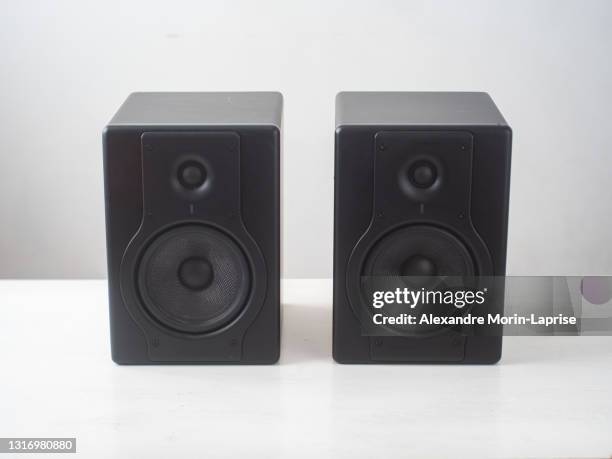 black pro studio speakers against a white and gray surface - audio hardware stock pictures, royalty-free photos & images