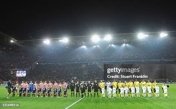 The players of Dortmund and Olympiacos line up at the start of the UEFA Champions League group F match between Borussia Dortmund and Olympiacos FC at...