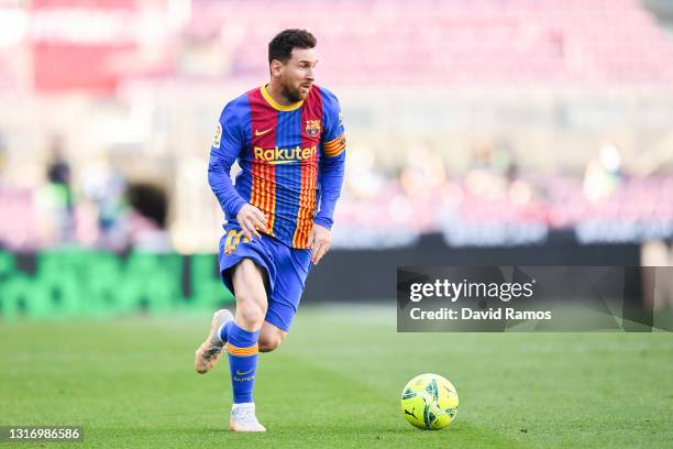 Lionel Messi of FC Barcelona runs with the ball during the La Liga Santander match between FC Barcelona and Atletico de Madrid at Camp Nou on May 08,...