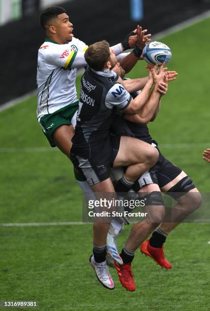 Ben Loader of London Irish competes for a high ball with Ben Stevenson and Mark Wilson of the Falcons during the Gallagher Premiership Rugby match...