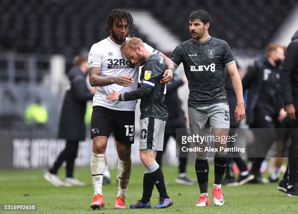 Colin Kazim-Richards of Derby County consoles Barry Bannan of Sheffield Wednesday after the Sky Bet Championship match between Derby County and...