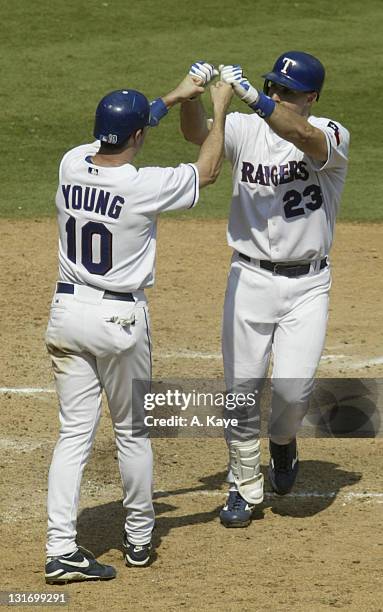 Rangers 1st Baseman Mark Tiexiera, high five's Michael Young after driving him in with his game winning home run. Texas Rangers sweep the Toronto...