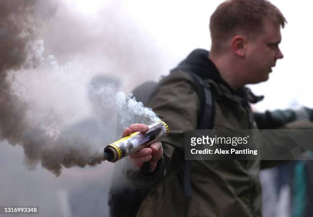 Supporter sets of a flare outside the stadium as Derby celebrate safety during the Sky Bet Championship match between Derby County and Sheffield...