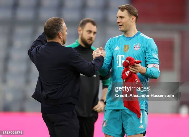 Manuel Neuer of FC Bayern Muenchen and Hans-Dieter Flick, Head Coach of FC Bayern Muenchen celebrate their side's victory and winning the Bundesliga...