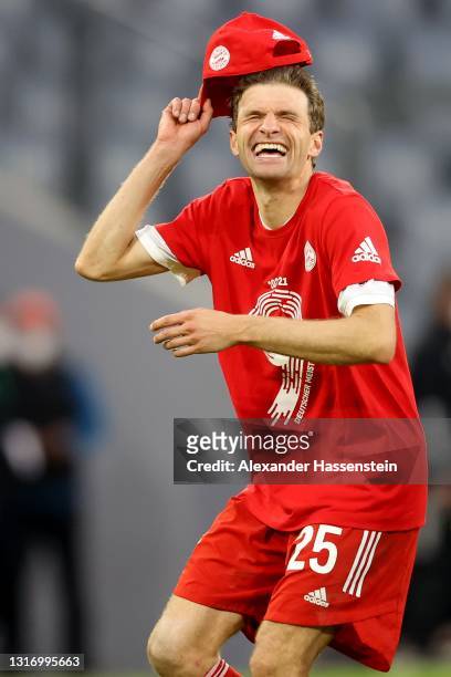 Thomas Müller of FC Bayern Muenchen celebrates winning the Bundesliga title after the Bundesliga match between FC Bayern Muenchen and Borussia...