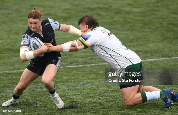 William Goodrick-Clarke of London Irish gets to grips with Falcons full back Tom Penny during the Gallagher Premiership Rugby match between Newcastle...