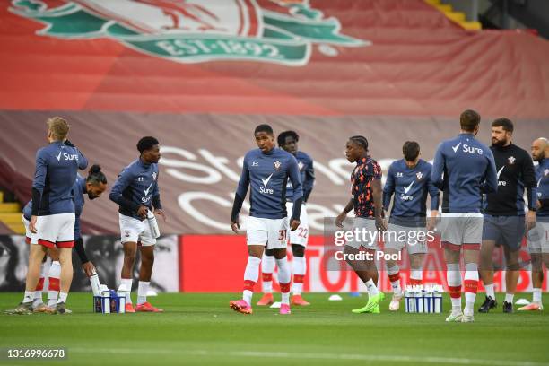 Kayne Ramsay of Southampton warms up with team mates prior to the Premier League match between Liverpool and Southampton at Anfield on May 08, 2021...