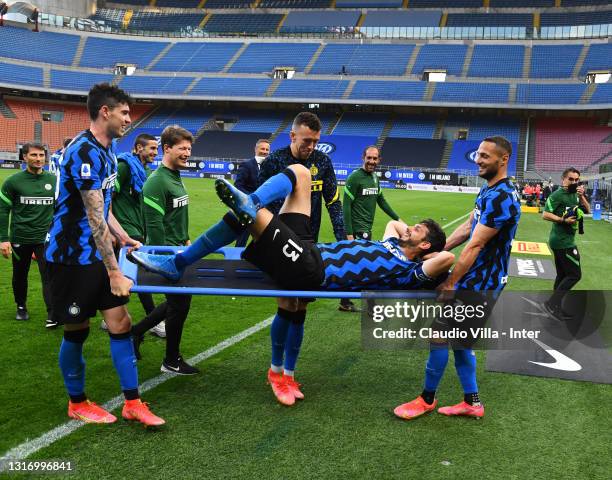 Andrea Ranocchia, Alessandro Bastoni and Danilo D'Ambrosio of FC Internazionale celebrate winning the championship at the end of the Serie A match...