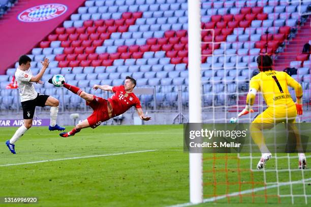 Robert Lewandowski of Bayern Muenchen scores his teams third goal past goalkeeper Yann Sommer of Borussia Moenchengladbach during the Bundesliga...