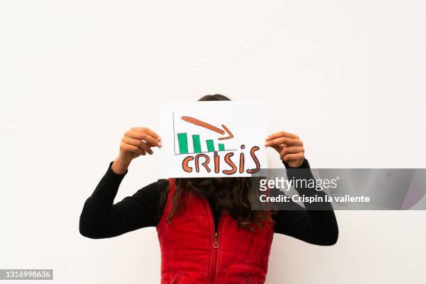 young woman demonstrating with a poster of the financial crisis - anti gravity stock pictures, royalty-free photos & images