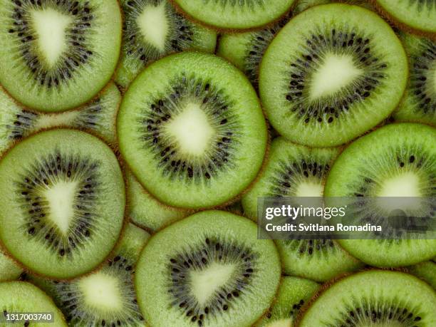 close-up photo of kiwi fruit slices.  background - kiwi fruit stock pictures, royalty-free photos & images