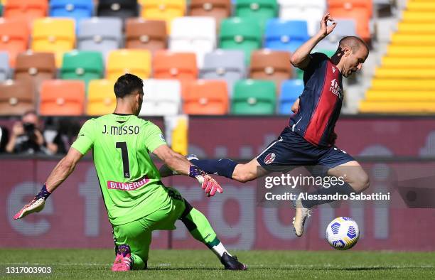 Juan Musso of Udinese Calcio makes a penalty foul against Rodrigo Palacio of Bologna FC during the Serie A match between Udinese Calcio and Bologna...