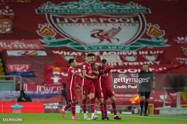 Thiago of Liverpool celebrates with team mates Roberto Firmino, Rhys Williams and Nathaniel Phillips after scoring their side's second goal during...