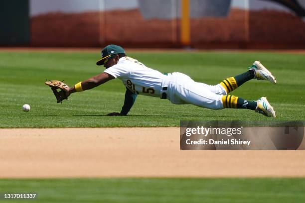 Tony Kemp of the Oakland Athletics makes a diving stop during the fourth inning against the Tampa Bay Rays at RingCentral Coliseum on May 08, 2021 in...