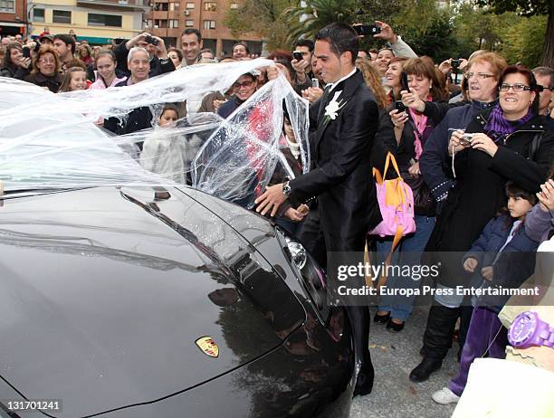 Three-time Tour de France champion Alberto Contador takes film off his car after his friends play a joke on him during his wedding at Santo Domingo...