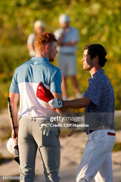 John Murphy of Team Great Britain and Ireland and Cole Hammer of Team USA meet on the 17th green after Hammer won their match during Saturday singles...