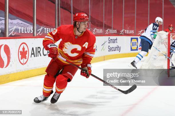 Sean Monahan of the Calgary Flames skates up ice against the Winnipeg Jets at Scotiabank Saddledome on May 5, 2021 in Calgary, Alberta, Canada.