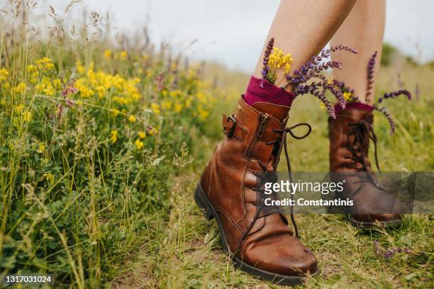 walking in boots full of spring - brown shoe stock pictures, royalty-free photos & images