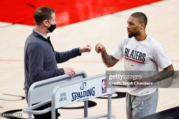 Head coach Terry Stotts and Damian Lillard of the Portland Trail Blazers fist bump before the game against the San Antonio Spurs at Moda Center on...