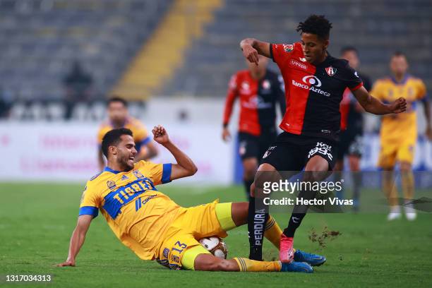 Diego Reyes of Tigres struggles for the ball against Jonathan Herrera of Atlas during the playoff match between Atlas and Tigres UANL as part of the...