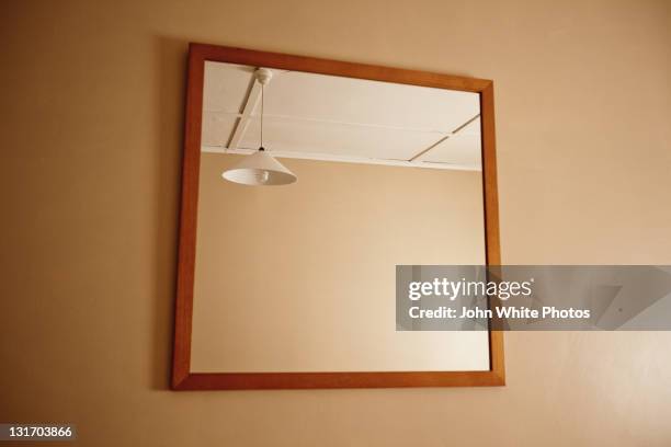 reflection of single light in empy room. - mirror with bulb stock pictures, royalty-free photos & images