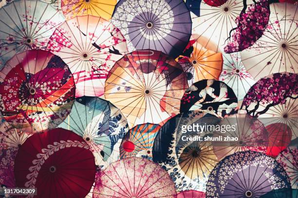 colorful umbrealla background - papierschirm stock-fotos und bilder
