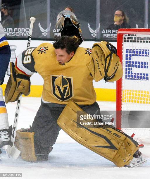 Marc-Andre Fleury of the Vegas Golden Knights reacts as his mask is accidentally knocked off by teammate Alec Martinez during their game against the...