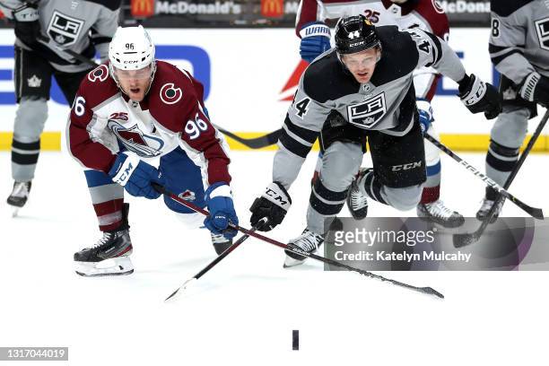 Mikko Rantanen of the Colorado Avalanche and Mikey Anderson of the Los Angeles Kings battle for control of the puck during the first period at...