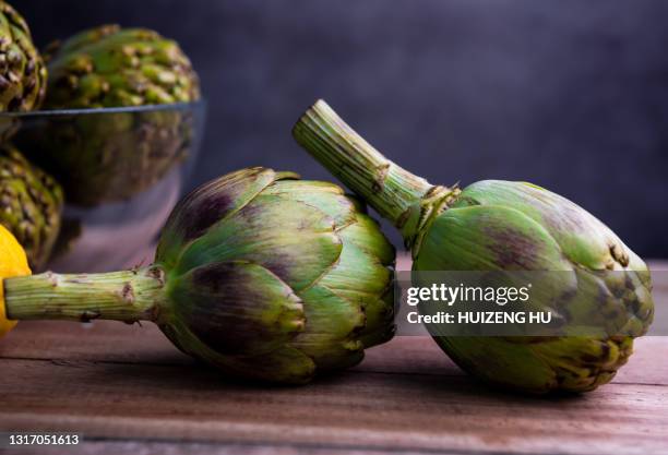 fresh artichokes and lemon - artichoke stock pictures, royalty-free photos & images