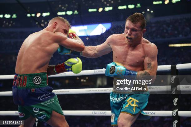 Canelo Alvarez punches Billy Joe Saunders during their fight for Alvarez's WBC and WBA super middleweight titles and Saunders' WBO super middleweight...