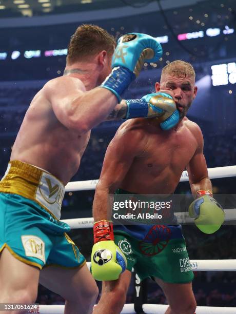 Canelo Alvarez punches Billy Joe Saunders during their fight for Alvarez's WBC and WBA super middleweight titles and Saunders' WBO super middleweight...