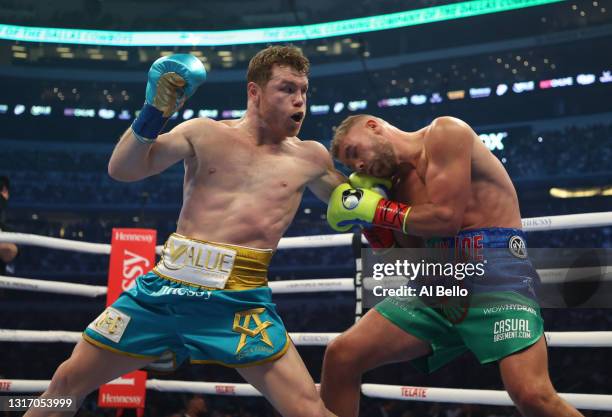 Canelo Alvarez punches Billy Joe Saunders during their fight for Alvarez's WBC and WBA super middleweight titles and Saunders' WBO super middleweight...