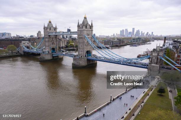 General view of Tower Bridge spanning the River Thames, with the Canary Wharf financial district visible in the distance is seen on May 08, 2021 in...