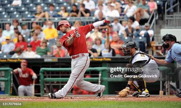 Ryan Roberts of the Arizona Diamondbacks bats as catcher Ryan Doumit of the Pittsburgh Pirates and umpire D.J. Reyburn look on during a game at PNC...