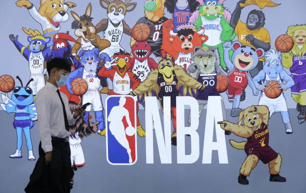 Visitor walks by NBA booth during the first China International Consumer Products Expo at Hainan International Convention and Exhibition Center on...