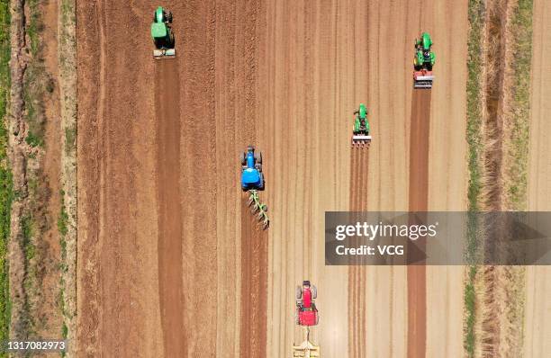Aerial view of seeding machines sowing sesame seeds in a field on May 7, 2021 in Binzhou, Shandong Province of China.