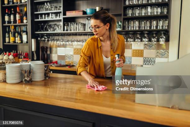 keeping her coffee shop clean - spray bottle stock pictures, royalty-free photos & images