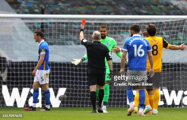 Robert Sanchez of Brighton and Hove Albion protests to Match Referee Jonathan Moss as team mate Lewis Dunk is shown a Red Card during the Premier...