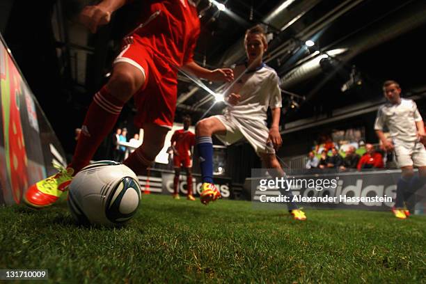 Young footballers play a demonstration match with the new adizero boots during the adidas adizero F50 miCoach launch event at Miller studio on...